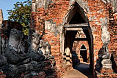 Ayutthaya, Thailand. Wat Chaiwatthanaram, the sitting Buddha statues aligned along the gallery have not survived, today only some headless pieces of the statues remain.